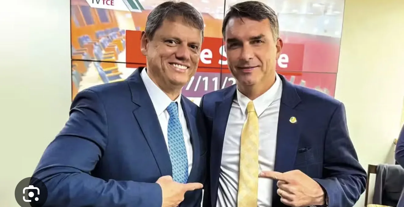 Imagem de Flávio Bolsonaro e Tarcísio de Freitas lado a lado em evento político, com fundo de bandeiras do Brasil e do PL, simbolizando união e lealdade na direita para 2026. Palav
